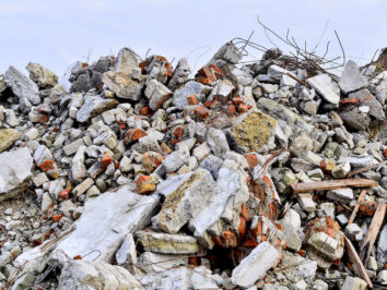 The rebar sticking up from piles of brick rubble, stone and concrete rubble. Remains of the destroyed industrial building.